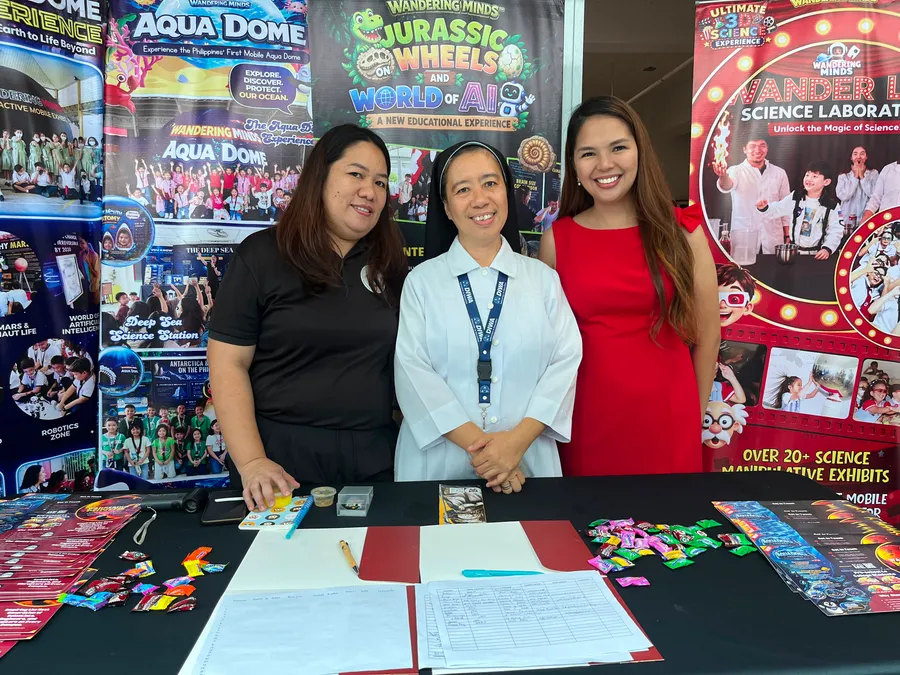 The Wandering Minds team welcoming a guest at their exhibit booth