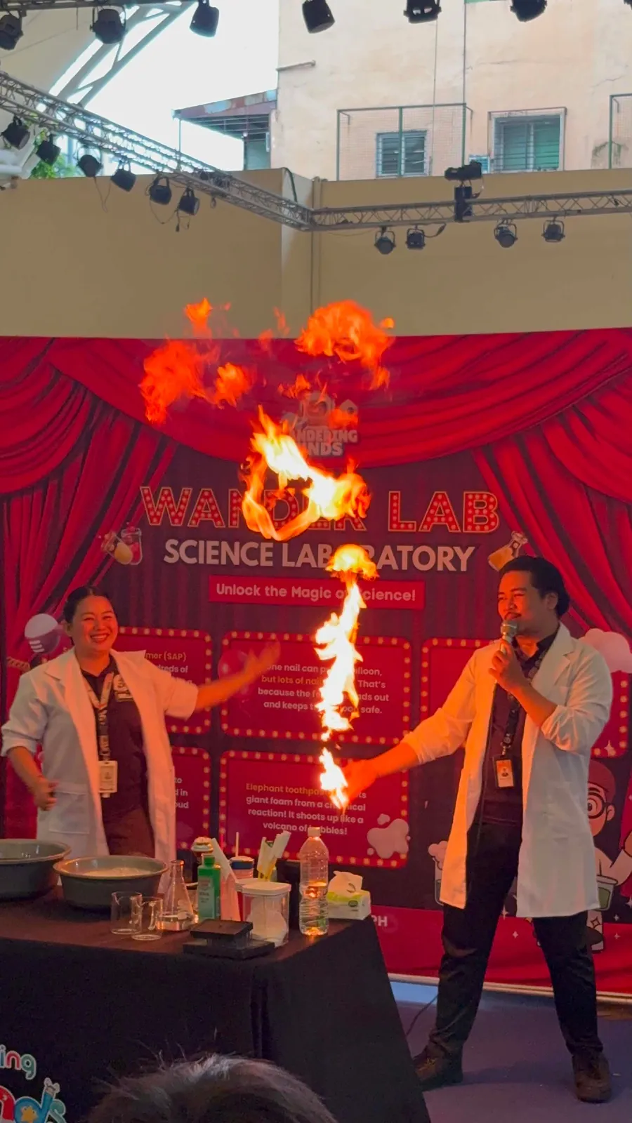 The WanderLab Science Show performing a live flame demonstration on stage
